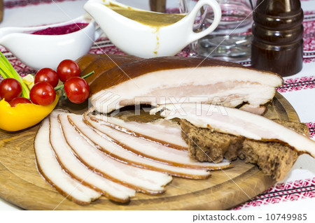 bacon on the table in a restaurant with sauce and vegetables bacon on the table in a restaurant with sauce and vegetables 10749985