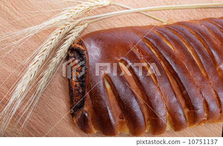Strudel with poppy seeds on a wooden table. Strudel with poppy seeds on a wooden table. 10751137