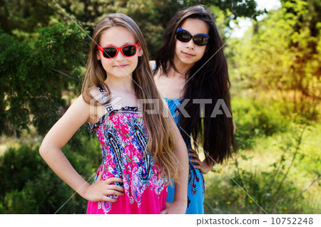 two sisters laying down in the park