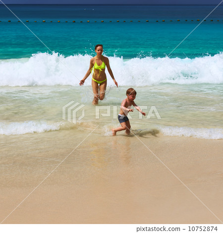 Mother and two year old boy playing on beach Mother and two year old boy playing on beach 10752874
