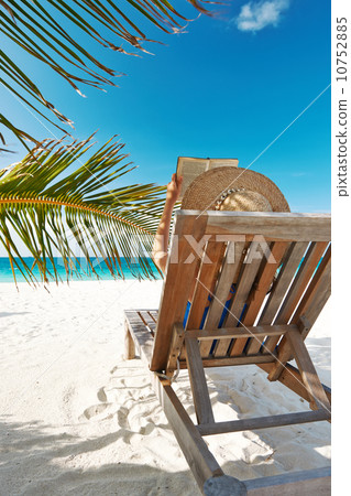 Young woman reading a book at beach 10752885