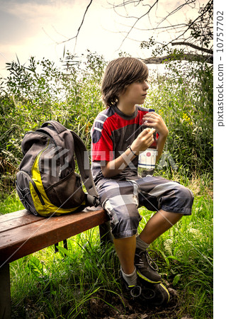 vintage style portrait of a teenager boy, having a break, while 10757702