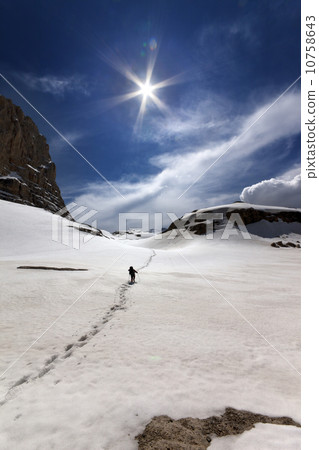 Hiker in snowy mountains 10758643