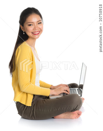 Side view Asian girl using notebook 10758918