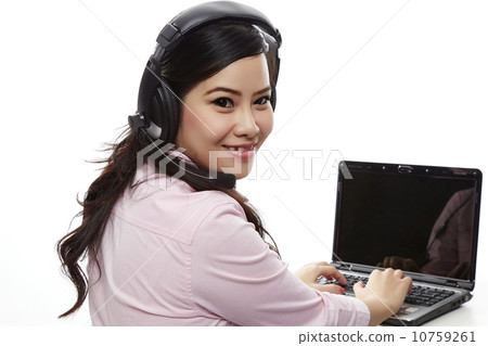 Call centre asian female helpline operator with headphones and l Call centre asian female helpline operator with headphones and l 10759261