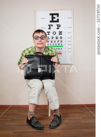 Funny manwearing spectacles in an office at the doctor 10759550