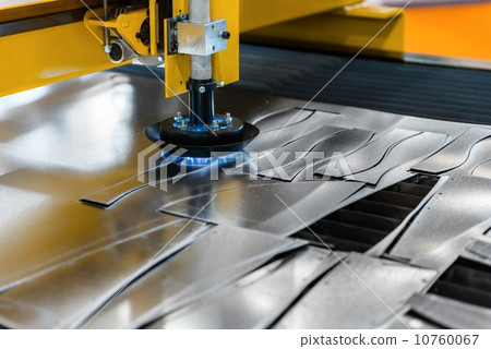 Machine cutting steel in a factory 10760067