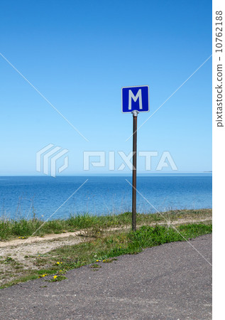 European road sign passing place by a road along coastline 10762188