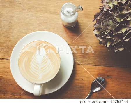 Cappuccino or latte coffee on table with retro filter effect 10763434