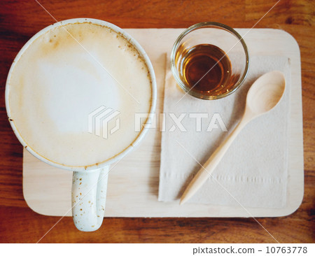 Cappuccino or latte coffee on wooden tray with syrup, retro filt 10763778