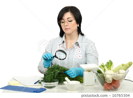 Phytosanitary technician carefully inspecting at a fresh dill 10765304