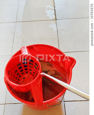 swab in red bucket with washing water swab in red bucket with washing water 10765870