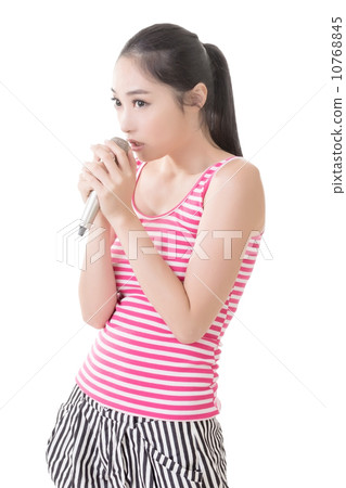 Asian girl take a microphone singing or speak 10768845
