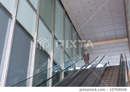 Asian business woman stand at escalator Asian business woman stand at escalator 10769046
