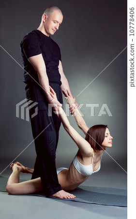 Image of experienced instructor helps girl in yoga 10778406