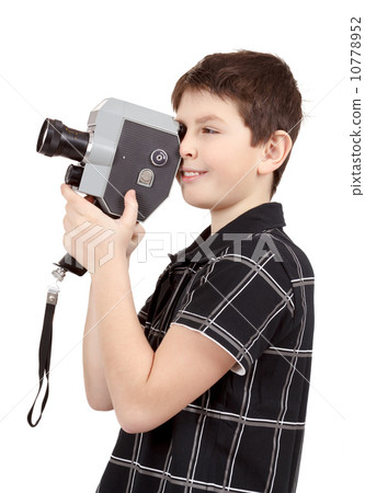 young boy with old vintage analog 8mm camera young boy with old vintage analog 8mm camera 10778952