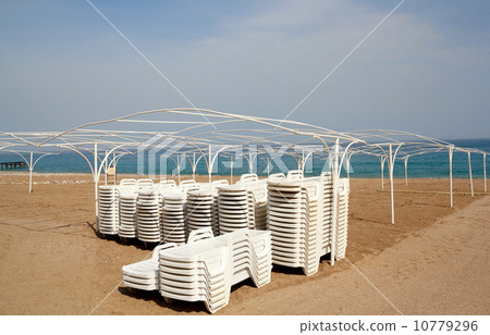 Empty beach with sun lounger Empty beach with sun lounger 10779296