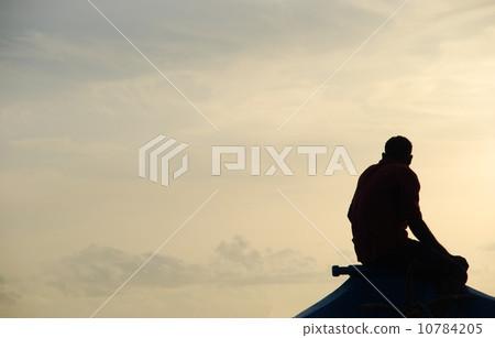 Silhouette of a fisherman on a typical Dhoni boat (sunset) 10784205