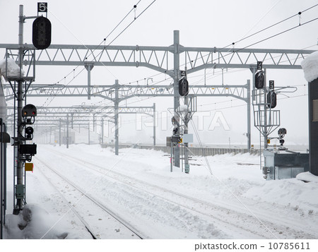 Many snowy railroad tracks in hazy winter 10785611