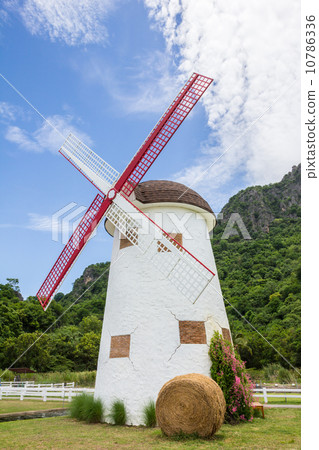 vintage windmill with straw bales 10786336
