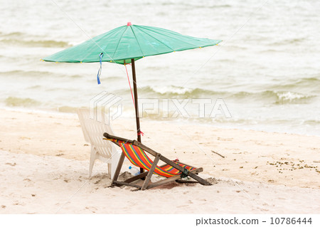 Beach chair with umbrella on the beach Beach chair with umbrella on the beach 10786444