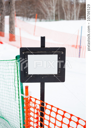 signpost in the snow in front of snow track 10786529