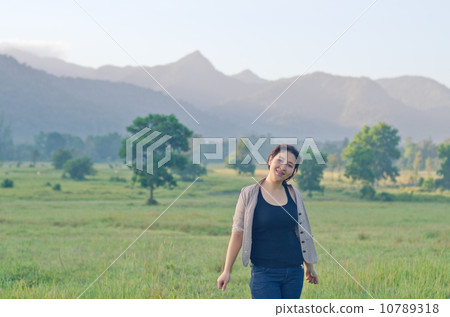 Pretty woman enjoying nature 10789318