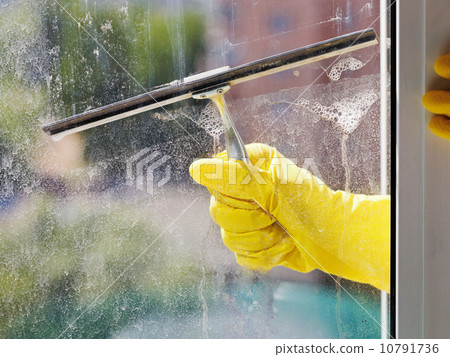 hand in yellow glove cleans window by squeegee hand in yellow glove cleans window by squeegee 10791736