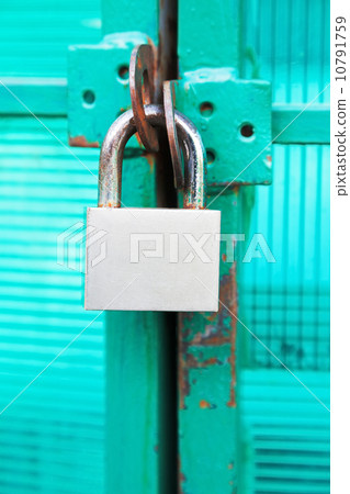 green door locked with steel padlock green door locked with steel padlock 10791759