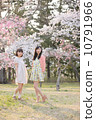 Two young women enjoying spring under the cherry tree 10791966