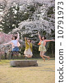 Three young women to jump under the cherry tree 10791973