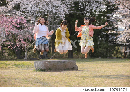 Three young women to jump under the cherry tree 10791974