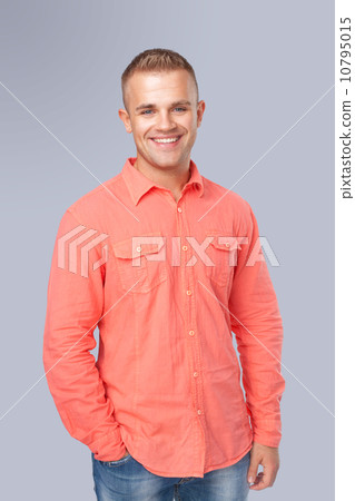 young man wearing a red shirt on gray background 10795015
