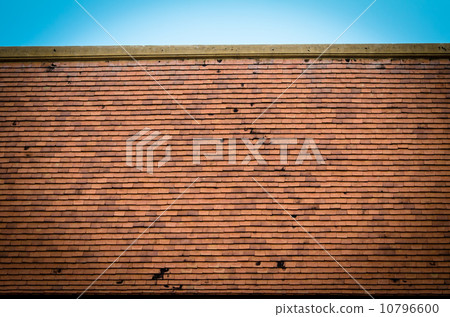 Old brown red rooftop against blue sky Old brown red rooftop against blue sky 10796600
