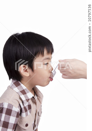 boy feeding medicine boy feeding medicine 10797536