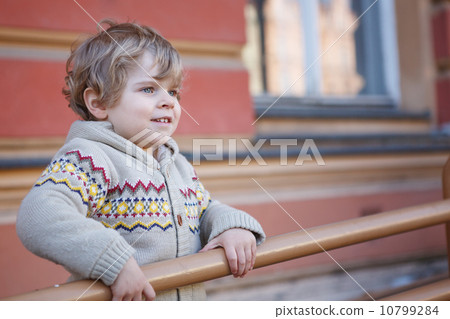 Little caucasian toddler boy having fun, outdoors Little caucasian toddler boy having fun, outdoors 10799284