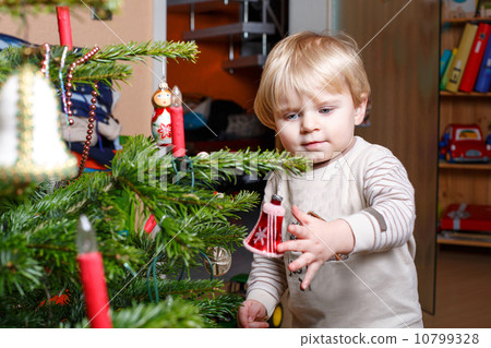 Little blond boy decorating Christmas tree at home. Little blond boy decorating Christmas tree at home. 10799328
