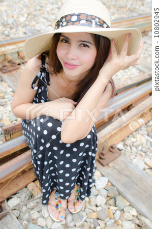 Traveller girl sitting on the rail way 10802945