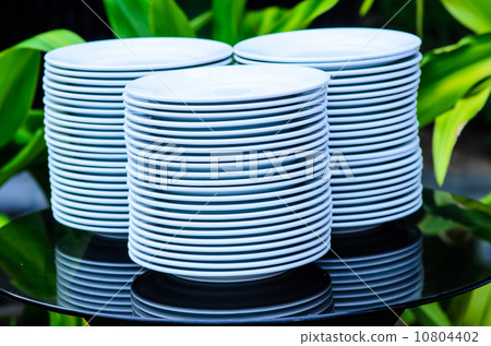 Clean white dishes set up on table Clean white dishes set up on table 10804402