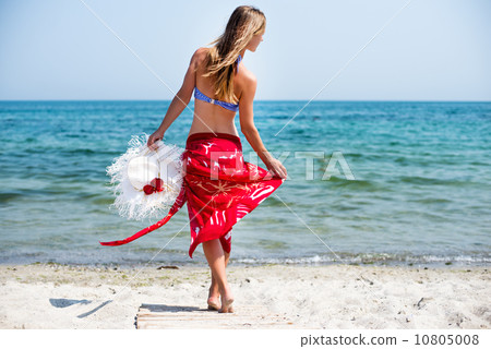 Woman walks at the beach Woman walks at the beach 10805008