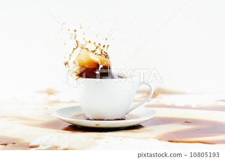 Cup of coffee creating splash. White background, coffee stains. 10805193