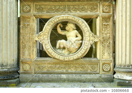 Antique sculpture of an angel, boy with grapes 10806668