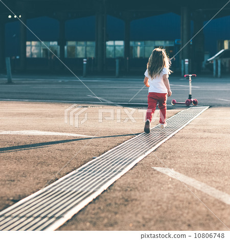 Little beautiful girl riding a scooter 10806748