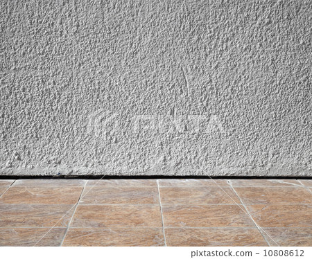 Abstract interior background with rough stucco wall and tiling f 10808612