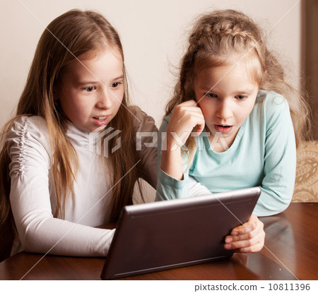 Children playing on tablet Children playing on tablet 10811396
