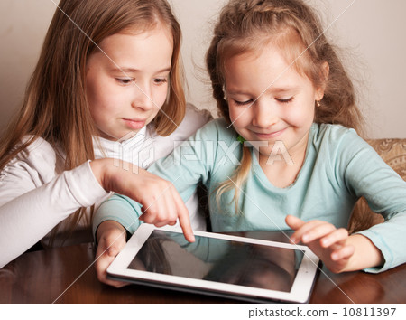 Children playing on tablet Children playing on tablet 10811397