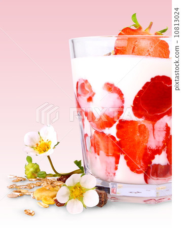 Red strawberries with white yogurt in glass, flowers and cereal 10813024