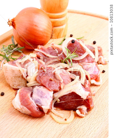 Lamb marinated with onion, spices and herbs on wooden board 10813038