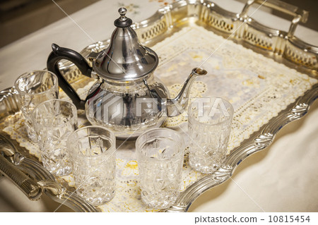 Arabic tea theme. Teapot with glasses on metal salver 10815454