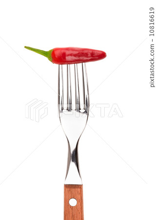 Spicy pepper paprika strung on a fork. On a white background. Spicy pepper paprika strung on a fork. On a white background. 10816619